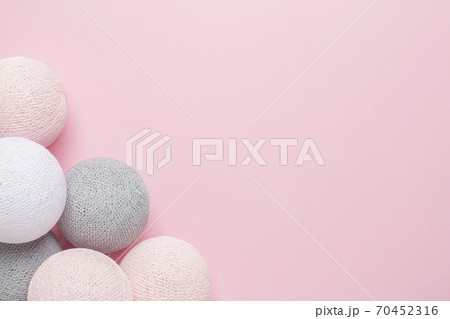 Pink, grey and white balls on a pastel background with copy space Pink, grey and white balls on a pastel background with copy space 70452316