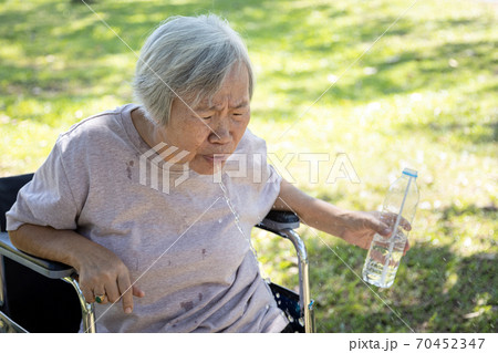 Asian senior woman choking on water,elderly people with poor quality water,bad smell and dirty of water, smelled plastic causing her to spitting out the water while drinking from plastic bottles Asian senior woman choking on water,elderly people with poor quality water,bad smell and dirty of water, smelled plastic causing her to spitting out the water while drinking from plastic bottles 70452347