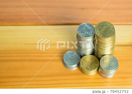 Stacks of coins on working table, finance and business concept, shallow focus. Stacks of coins on working table, finance and business concept, shallow focus. 70452752