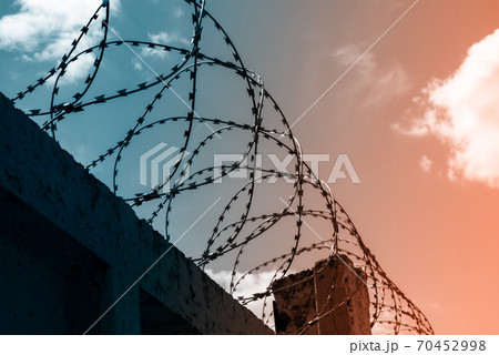 Barbed wire against the sky 70452998