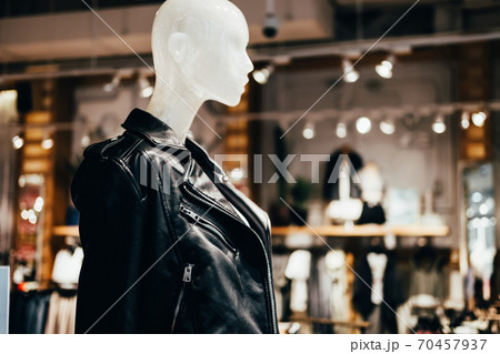 White mannequin in black leather jacket in fashion store, selective focus White mannequin in black leather jacket in fashion store, selective focus 70457937