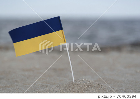 National flag of Ukraine on seashore. Blue and yellow flag. National flag of Ukraine on seashore. Blue and yellow flag. 70460594