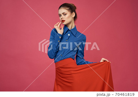 Woman in blue shirt and red cubes on pink background fun emotions model cropped view 70461819