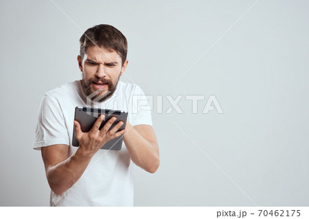 emotional man with tablet in hand touch screen new technologies light background cropped view Copy Space 70462175