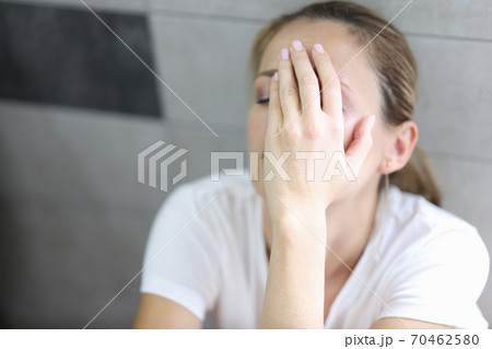 Woman in depression sits with closed eyes Woman in depression sits with closed eyes 70462580