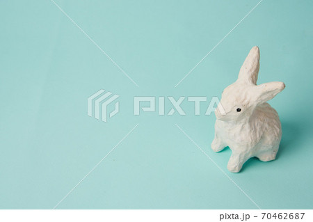 Festive white rabbit toy on a blue background with pastel colors Easter Festive white rabbit toy on a blue background with pastel colors Easter 70462687