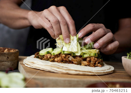 man preparing a durum or a burrito 70463251