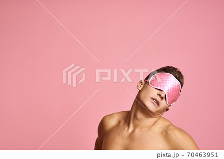 man in pink sleep mask on pink background naked shoulders morning man in pink sleep mask on pink background naked shoulders morning 70463951