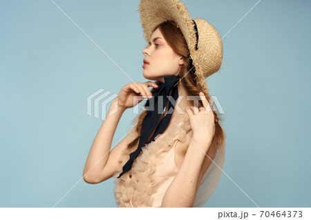 Romantic girl in a straw hat on a gray background and a beige sundress black ribbon emotions model Romantic girl in a straw hat on a gray background and a beige sundress black ribbon emotions model 70464373