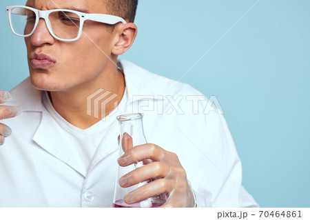 man holding flasks colorful liquid chemical laboratory model wearing glasses 70464861