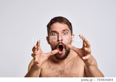 Bearded man with bare shoulders cotton swabs hygiene body care 70464864