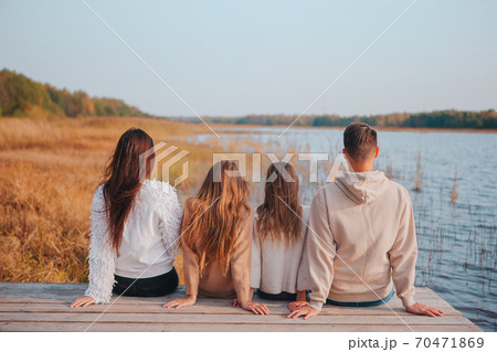 Beautiful family at autumn warm day near lake 70471869