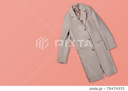 gray fashionable female coat on a pink background, concept of shopping and fashion 70474355