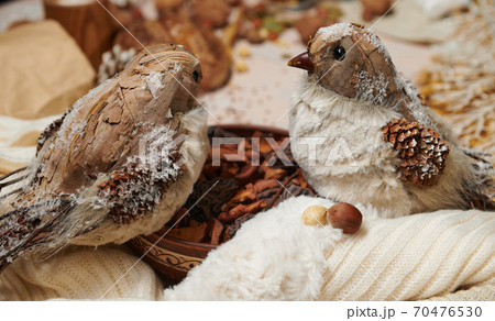 christmas decoration in rustic style and holiday background, still life on wooden backdrop, a stuffed bird and other 70476530