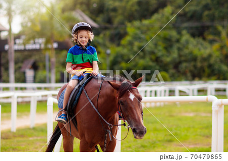 Kids ride horse. Child on pony. Horseback riding. Kids ride horse. Child on pony. Horseback riding. 70479865