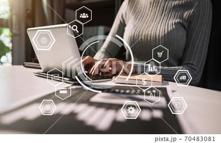 Businesswoman using mobile phone and laptop computer on white desk big data analytics with business intelligence concept. with VR chart and graph with icon 70483081