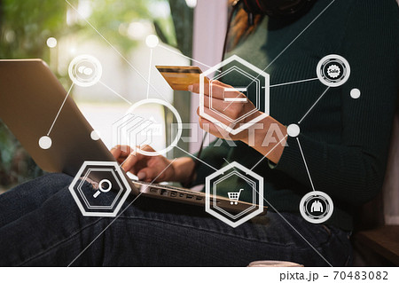 hipster hand using smart phone for mobile payments online business,headphone,sitting. Online Shopping payments  concept. 70483082