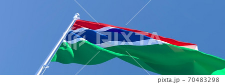 3D rendering of the national flag of Gambia waving in the wind against a blue sky 70483298