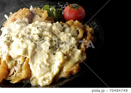 ミニトマトなど野菜も一緒に乗っているタルタルソースたっぷりの熱々チキン南蛮丼（黒背景） 70484749