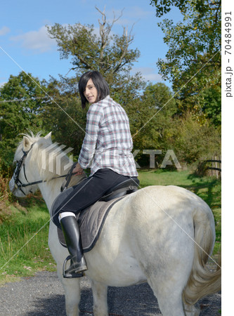 young beautiful brunette woman riding horse 70484991