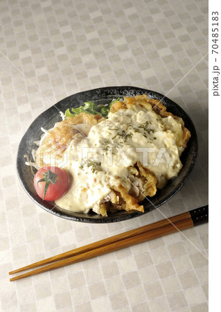ミニトマトなど野菜も一緒に乗っているタルタルソースたっぷりの熱々チキン南蛮丼とお箸 70485183