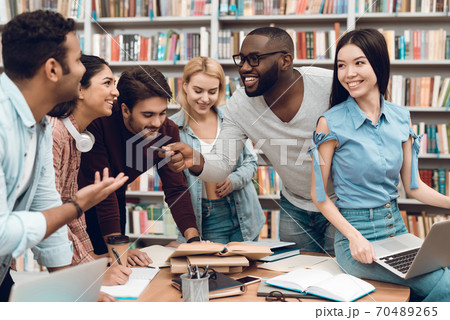 Young people at the table smiling and chatting. Young people at the table smiling and chatting. 70489265