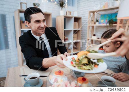 The man came home after work and eats. The man came home after work and eats. 70489802