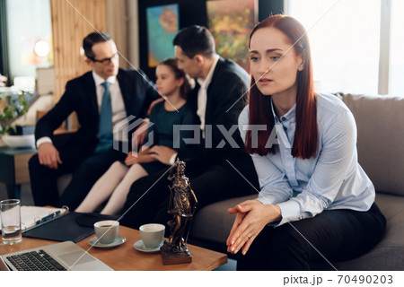 A woman in a shirt sits and folded her arms.  70490203