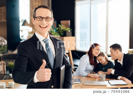 A man stands with his finger up and smiling. A man stands with his finger up and smiling. 70491066