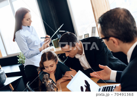 Woman signs a contract in the office of a lawyer. Woman signs a contract in the office of a lawyer. 70491368