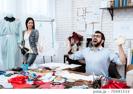 Fashion designer frustrated drawing at work. Fashion designer frustrated drawing at work. 70491533