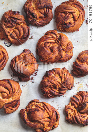 Traditional Swedish buns with cardamom and cinnamon, light background, top view. Scandinavian cuisine concept. 70491799