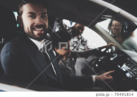 Man salesman sitting in a car in suit and smiling. Man salesman sitting in a car in suit and smiling. 70491814