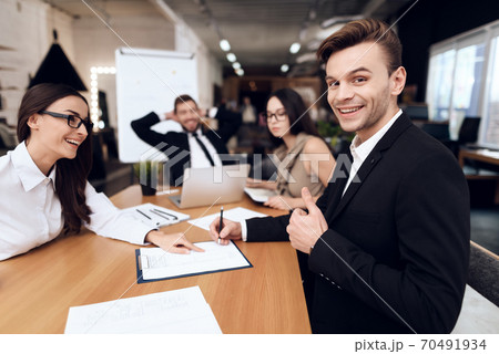 Employees of company hold a meeting at the table. Employees of company hold a meeting at the table. 70491934