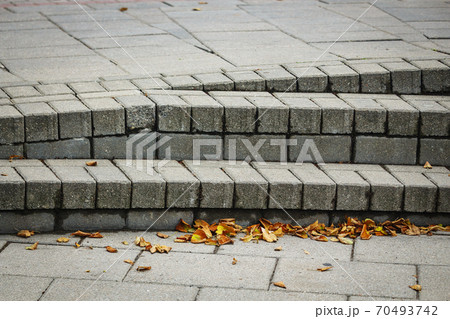 Weird architecture design uneven stairs with yellow fallen leaves Weird architecture design uneven stairs with yellow fallen leaves 70493742