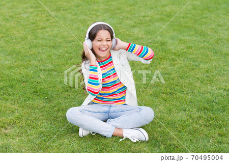Pleasant time. Child headphones listen music. Do not bother me. Cool girl headphones listening 70495004