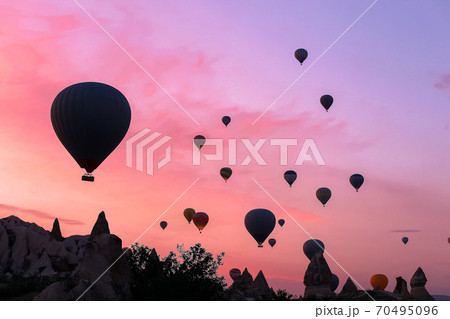 Hot air ballons flying over Cappadocia in sunrise sky, Turkey. 70495096