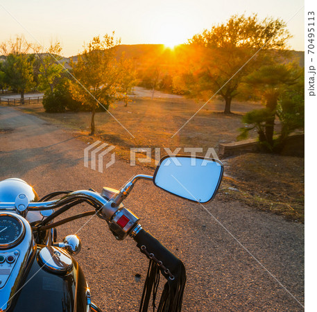 Motorcycle on a country road at sunset 70495113