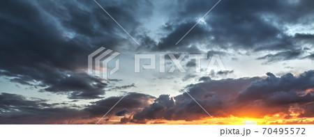 Dark clouds and bright sun 70495572