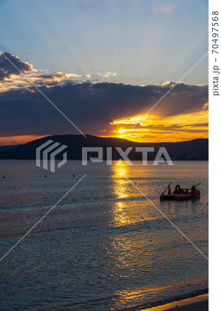Dark clouds over Alghero shore at sunset 70497568