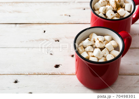Christmas cocoa with marshmallow in mug on white wooden table. Copyspace	 70498301