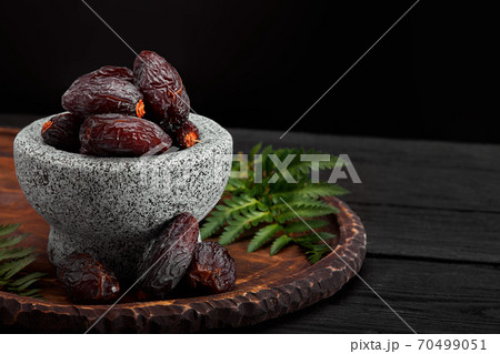 Bowl of dried dates on dark wooden background 70499051