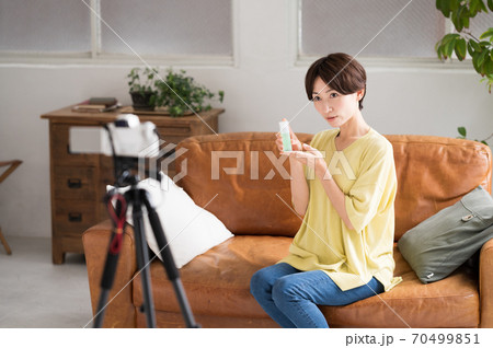 カメラの前でオススメの化粧品を動画配信する女性 カメラの前でオススメの化粧品を動画配信する女性 70499851