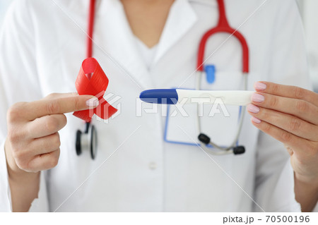 Doctor in white coat hold lgbt symbol and in another pregnancy test. 70500196
