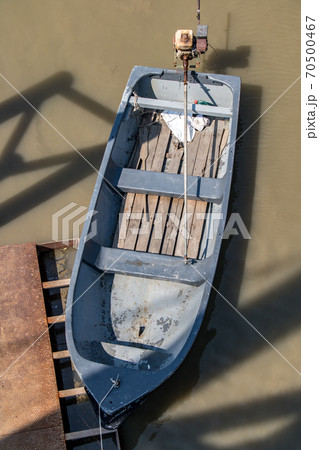 A empty punt tied at the river bank, top view. 70500467