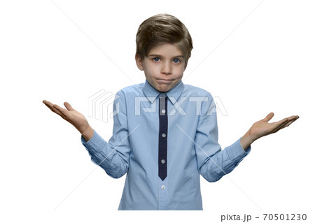 Little boy shrugging shoulders expressing doubt or lack of knowledge. 70501230