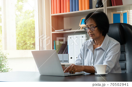 Happy senior Asian using the laptop for calculating and make a note of daily expenses. Concept of lifestyle, learning, and finance business Happy senior Asian using the laptop for calculating and make a note of daily expenses. Concept of lifestyle, learning, and finance business 70502941