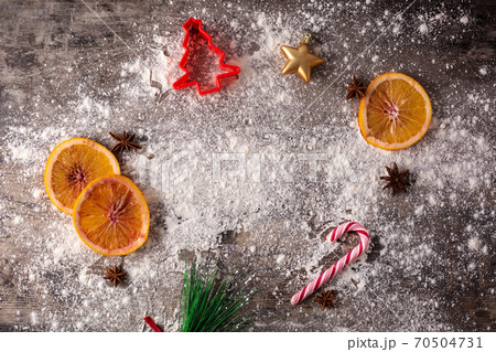 Christmas food background with oranges, star anise and flour on wooden background. Ingredients for Christmas dessert 70504731