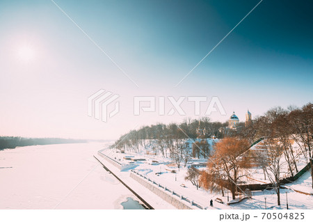 Gomel, Belarus. Winter City Park, Frozen River, Embankment And Peter And Paul Cathedral In Sunny Winter Day. Famous Local Landmark In Snow 70504825