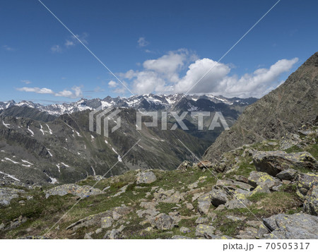 view of mountain and snow-capped peaks at Stubai hiking trail, Stubai Hohenweg, Summer rocky alpine landscape of Tyrol, Stubai Alps, Austria view of mountain and snow-capped peaks at Stubai hiking trail, Stubai Hohenweg, Summer rocky alpine landscape of Tyrol, Stubai Alps, Austria 70505317